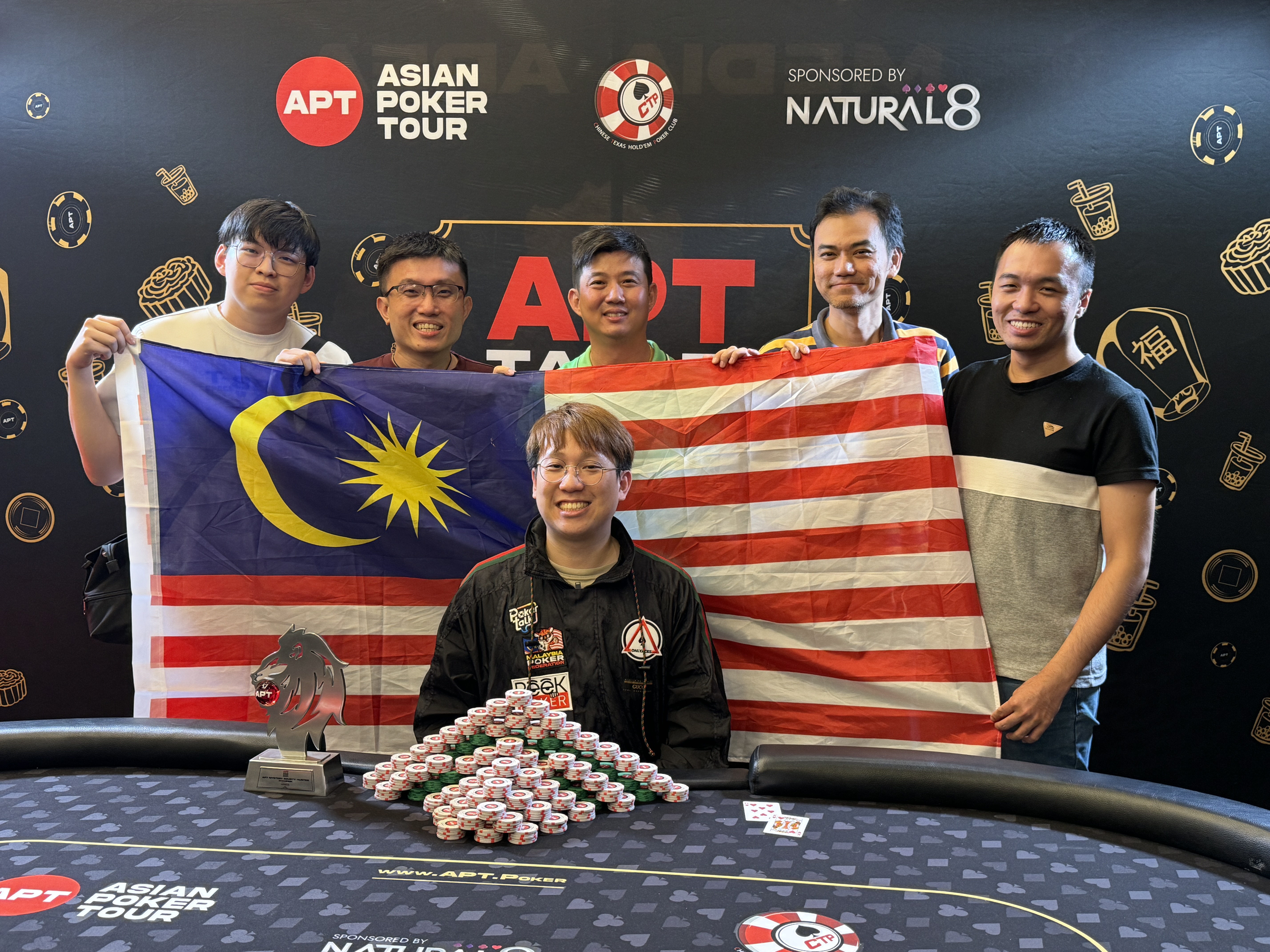 group of people holding malaysian flag