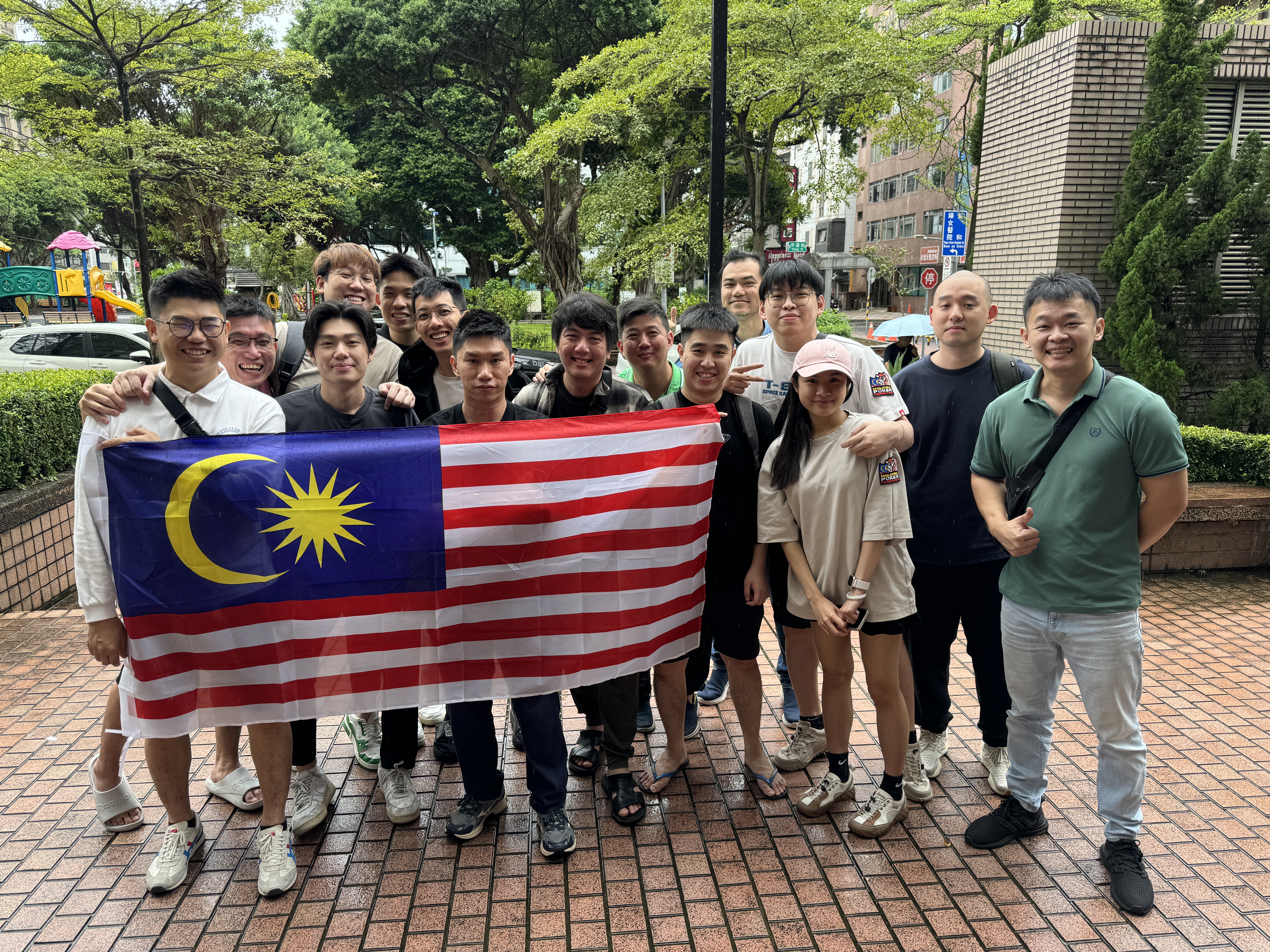 group of people holding malaysian flag